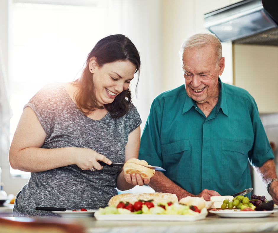 Adult daughter cooking with senior aged father