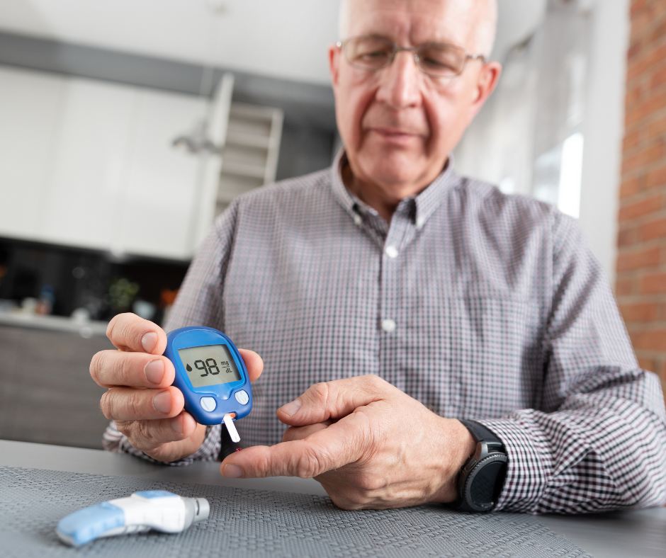 Senior man testing blood with glucose meter