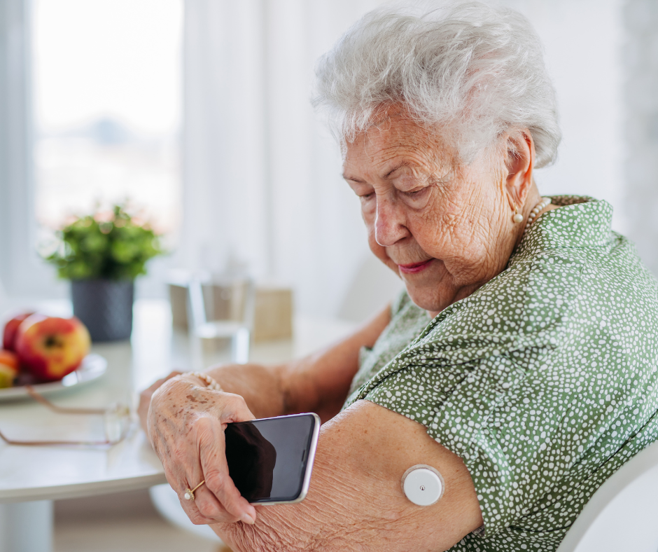 Senior woman using phone to monitor blood glucose levels